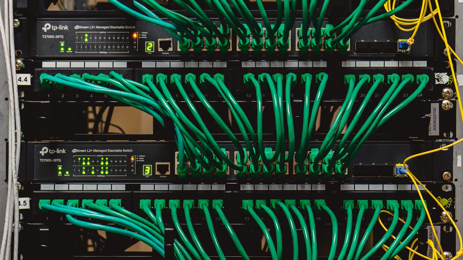 Network rack with cabling and infrastructure equipment for site planning context.