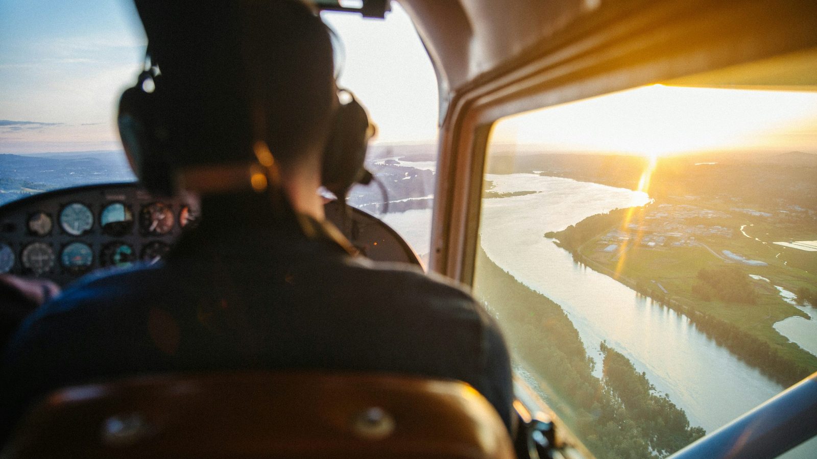 Cockpit view over a river environment for enroute planning and navigation context.